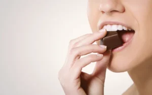 woman eating polkadot chocolates